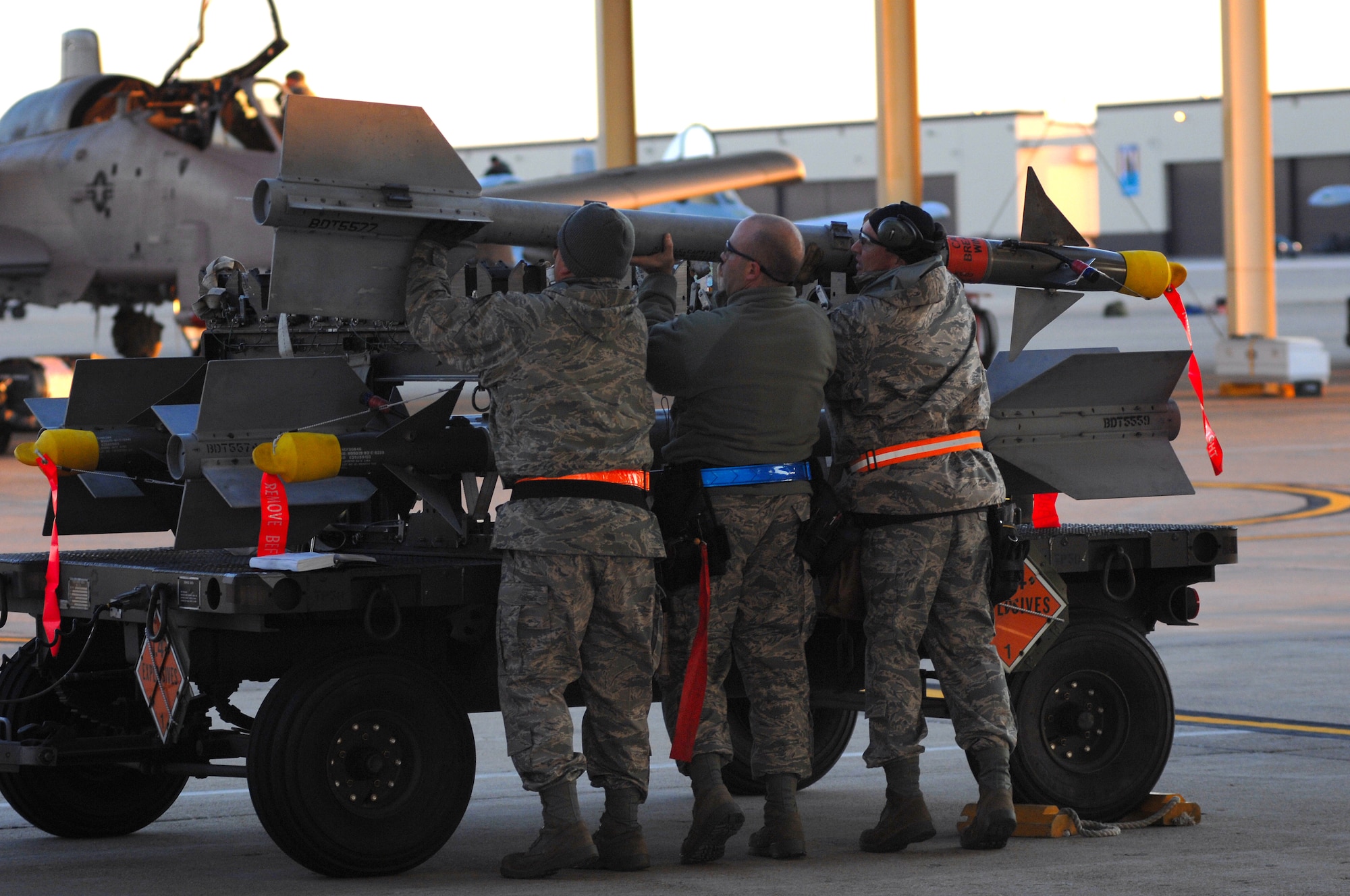 WHITEMAN AIR FORCE BASE, Mo. - Tech Sgts. Shaun McCrea, Wesley Peel and Staff Sgt. Dean Gross, 442nd Fighter Wing, work as a team to download A-10 Thunderbolt II munitions, during an Operational Readiness Inspection, Oct. 26. 442nd FW personnel worked around the clock in cold and wet weather conditions during the four-day exercise. The ORI prepared Airmen for real-world deployment situations such as chemical and biological attacks and other scenarios. (U.S. Air Force photo/Senior Airman Kenny Holston)(Released) 