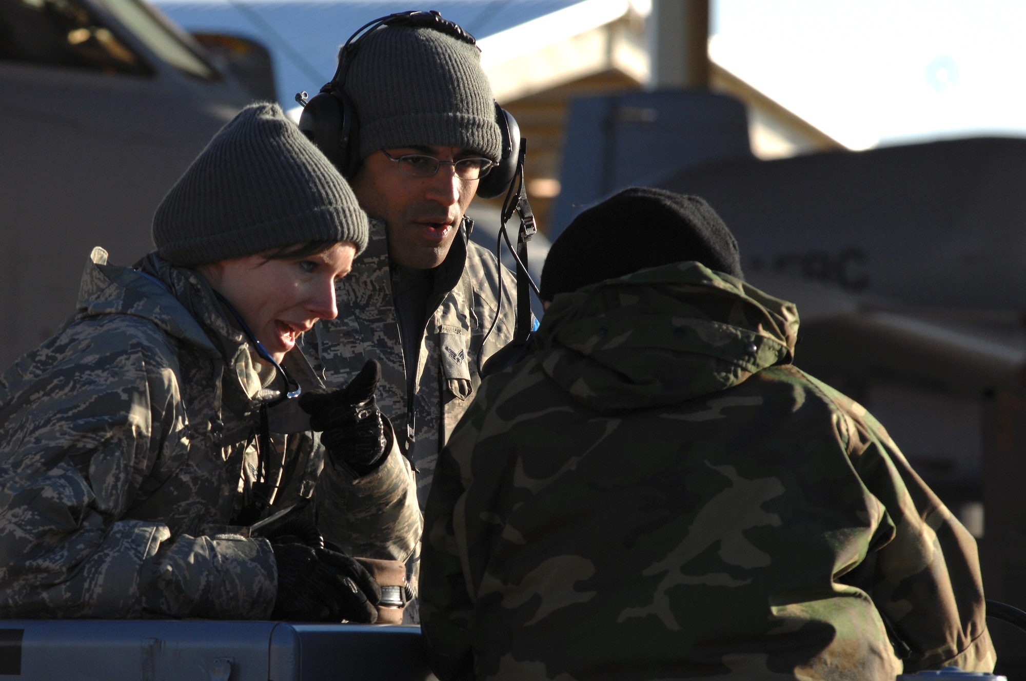 WHITEMAN AIR FORCE BASE, Mo. - Senior Airman Cecil Brushwood and Sara Bower, 442nd Fighter Wing avionics technicians discuss mission requirements with Senior Airman Kiley Devericks, 442nd FW avionics technician, during an Operational Readiness Inspection, Oct. 24. 442nd FW personnel worked around the clock in cold and wet weather conditions during the four-day exercise. The ORI prepared Airmen for real-world deployment situations such as chemical and biological attacks and other scenarios. (U.S. Air Force photo/Senior Airman Kenny Holston)(Released) 