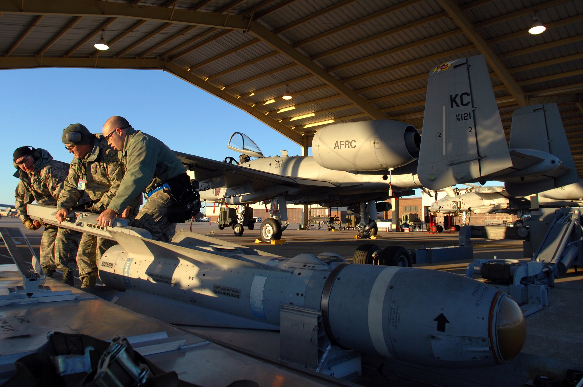 WHITEMAN AIR FORCE BASE, Mo. - Tech Sgts. Shaun McCrea, Wesley Peel and Staff Sgt. Dean Gross, 442nd Fighter Wing, secure A-10 Thunderbolt II munitions after downloading them during an Operational Readiness Inspection, Oct. 24. 442nd FW personnel worked around the clock in cold and wet weather conditions during the four-day exercise. The ORI prepared Airmen for real-world deployment situations such as chemical and biological attacks and other scenarios. (U.S. Air Force photo/Senior Airman Kenny Holston)(Released) 