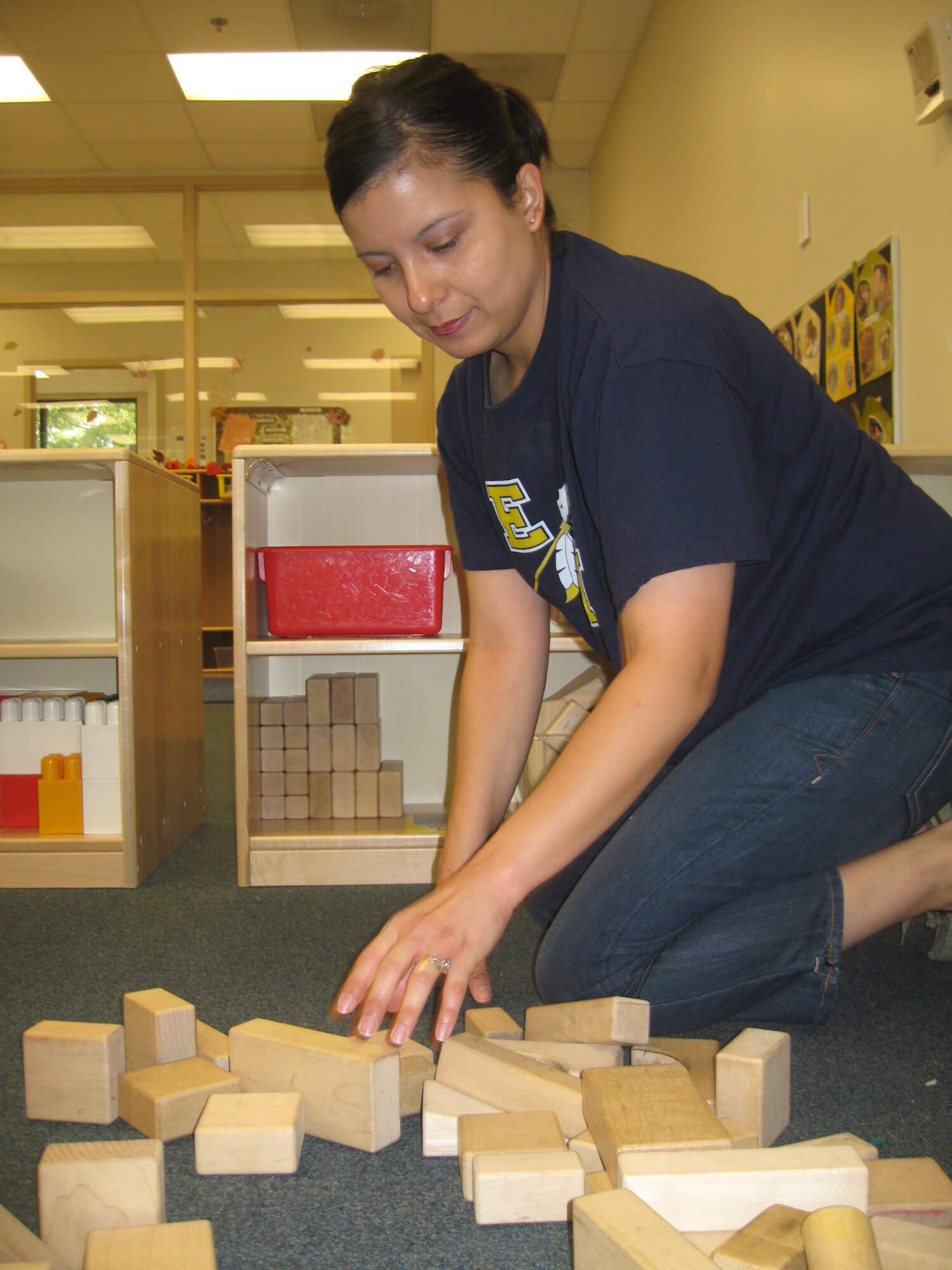 Jeanette Estrada, child development center education technician, places blocks onto newly assembled shelves in her class room as part of “Make a Difference Day” at Seymour Johnson Air Base Oct. 24, 2009. More than 75 volunteers spent the day at the CDC building and replacing furniture in 14 classrooms, mounting chair rails, pressure washed the building, performing yard work and other tasks. (U.S. Air Force photo/Senior Airman Courtney Richardson)