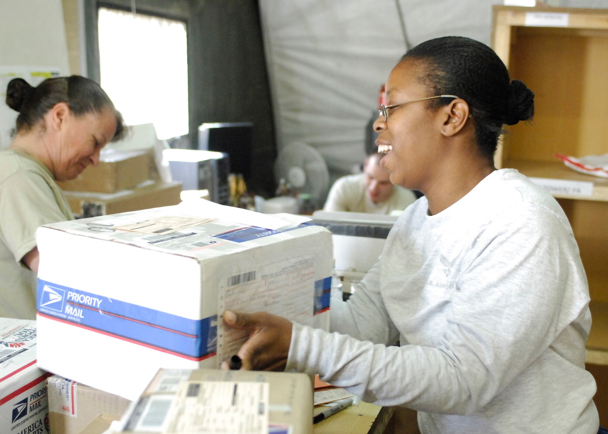 Staff Sgt. Shervon Greenhow helps sort mail at the Air Force mail center Oct. 22, 2009, in Camp Cunningham, Afghanistan. Sergeant Greenhow is assigned to the 455th Expeditionary Communications Squadron and is deployed from Andrews Air Force Base, Md. She is a native of Savannah, Ga. (U.S. Air Force photo/Senior Airman Felicia Juenke) 