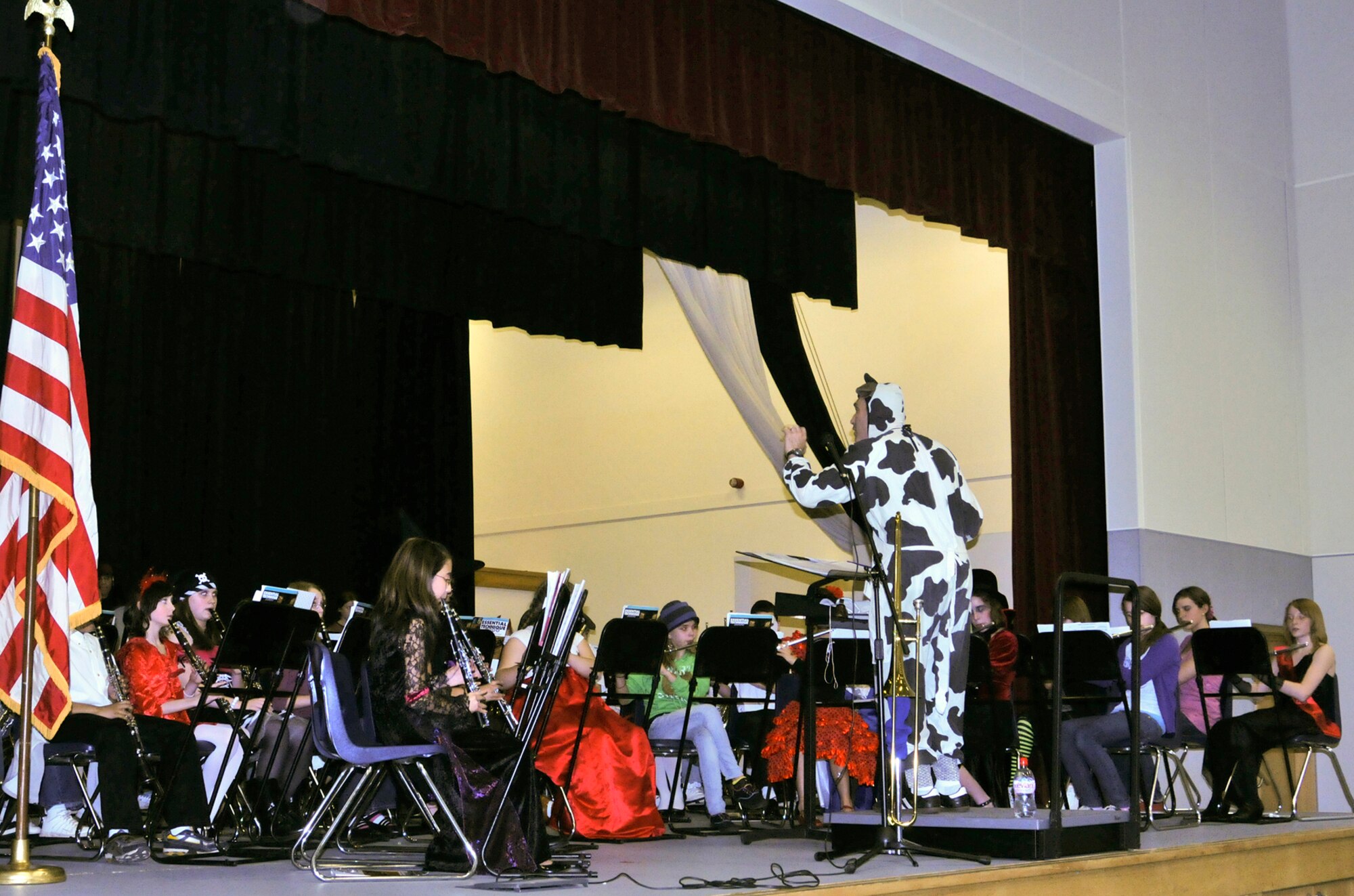 RAF LAKENHEATH, England -- 'Mooo-sic' was on the agenda at RAF Lakenheath Middle School Oct. 27 as conductor Wes "Cow about that" Bloom led his 70-member Advanced Band in their Fall Costume Party Concert. The Advanced Band featured 6th-, 7th- and 8th-grade brass, woodwind and percussion musicians hailing from RAFs Mildenhall, Lakenheath and Feltwell. This was the first concert the band held this school year. They are now preparing for their Winter Concert, scheduled for Dec. 16 at the middle school. (U.S. Air Force photo/Tech. Sgt. Kevin Wallace)