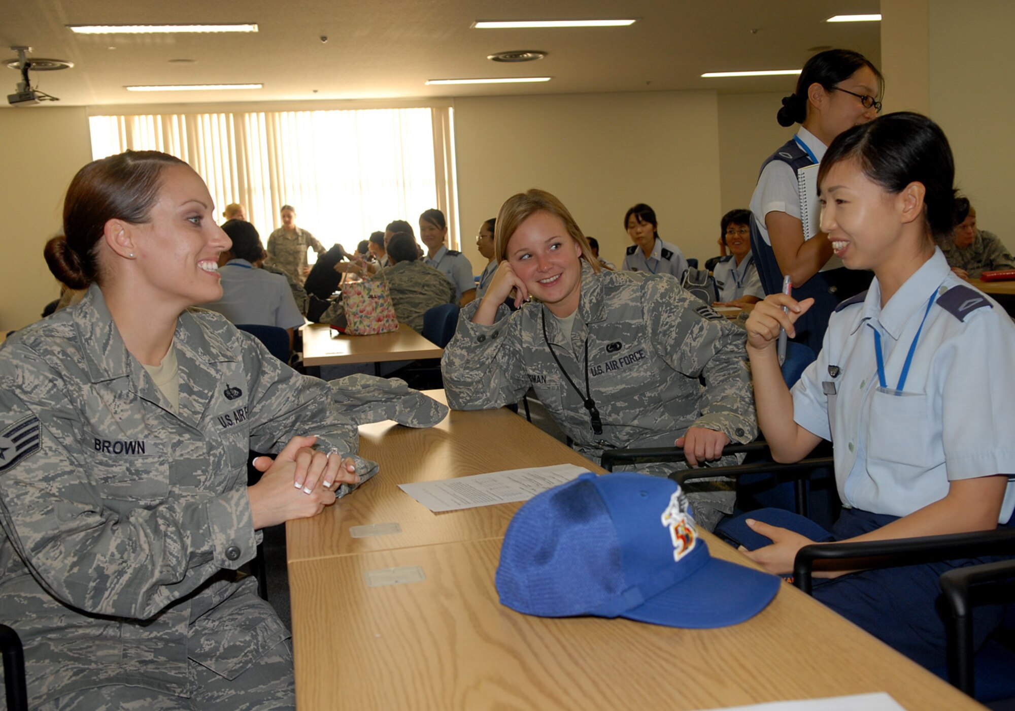 During a seminar at the education and training center at Kadena Air Base, Staff Sgt. Lacey Brown (far left), from the 18th Force Support Squadron and Staff Sgt. Amber Ledman(center), from the 82nd Reconnaissance Squadron, interact with Staff Sgt. Saori Nakamura(far right),  of the 83rd Air Wing from Naha Air Base.  The Japan Air Self-Defense Force Airmen were visiting for a seminar and tour of Kadena Air Base on Oct. 28. (U.S. Air Force photo/Junko Kinjo)


