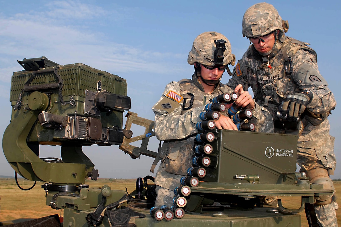 U.S. Army Spc. Timothy Cooke, left, and Sgt. Kyle O'Leary prepare to shoot a grenade launcher during range training during Yudh Abhyas on Camp Bundela in Babina, India, Oct. 15, 2009. The soldiers are assigned to the 25th Infantry Division's 2nd Squadron, 14th Cavalry Regiment, 2nd Stryker Brigade Combat Team.
