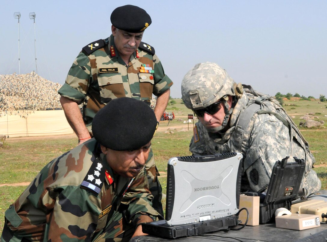 Indian Army Brig. Gen. RS Yadav, left, Maj. Gen. Anil Malik, middle, and U.S. Army Lt. Col. James Isenhower watch the flight of an unmanned aerial vehicle on a computer as part of a demonstration during Yudh Abhyas on Camp Bundela in Babina, India, Oct. 16, 2009.  Isenhower is commander of the 25th Infantry Division's 2nd Squadron, 14th Cavalry Regiment, 2nd Stryker Brigade Combat Team.