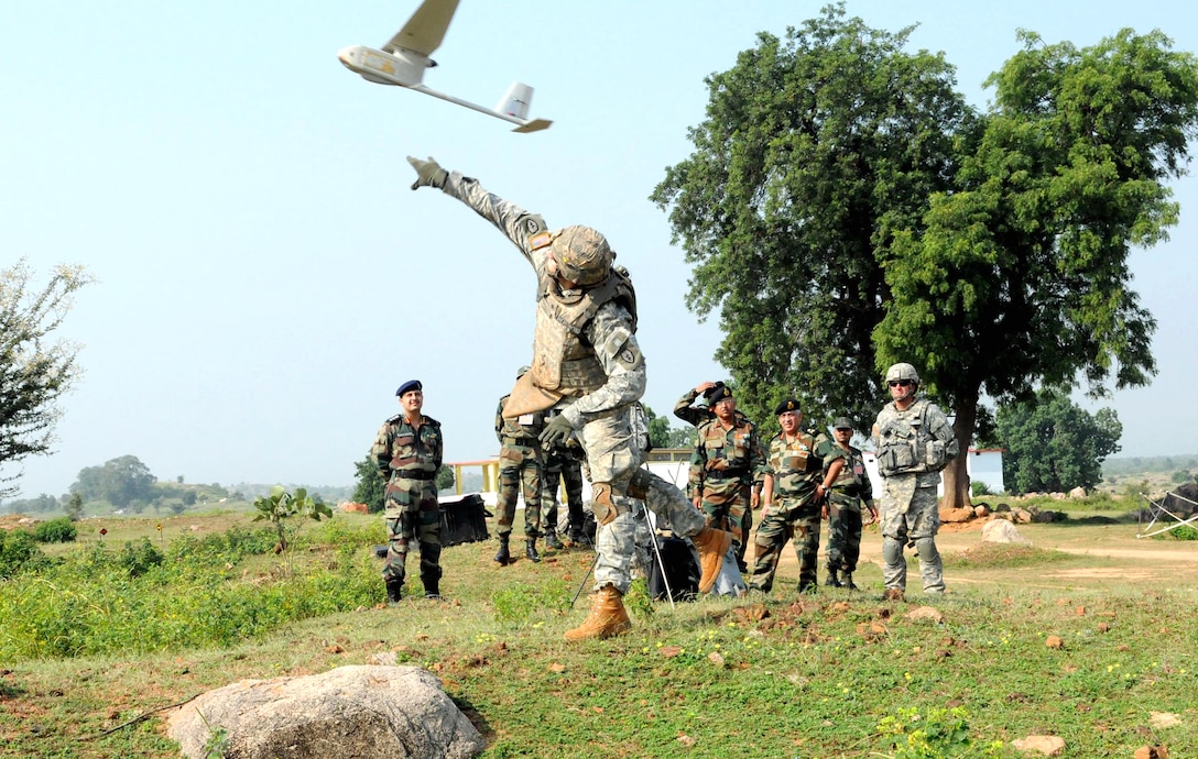 U.S. Army Spc. David Swan tosses an unmanned aerial vehicle, showing the its capabilities to the Indian soldiers during Yudh Abhyas on Camp Bundela in Babina, India, Oct. 16, 2009. Swan is assigned to the 25th Infantry Division's 2nd Squadron, 14th Cavalry Regiment, 2nd Stryker Brigade Combat Team.