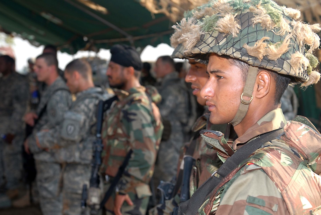Indian army soldiers from the 7th mechanized infantry regiment, and U.S. Army Soldiers receive instructions for maneuvering together during range training at Exercise Yudh Abyas 09, a bilateral exercise involving the Armies of India and the United States. 