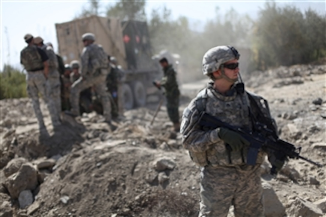 U.S. Army Staff Sgt. Douglas Noreen assigned to 2nd Battalion, 87th Infantry Regiment, 3rd Brigade Combat Team, 10th Mountain Division provides security for his convoy in the Nerkh district of Wardak province, Afghanistan, on Oct. 21, 2009.  