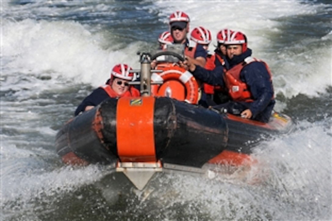 U.S. Coast Guard Petty Officer 2nd Class Christian Wallace manuevers a cutter's small boat as part of a demonstration for a group of Navy Junior Reserve Officers Training Corp in the Gulf of Mexico, Oct. 20, 2009.