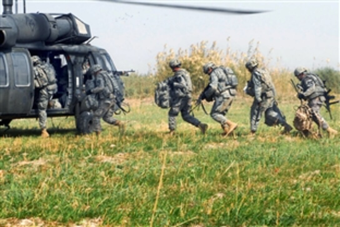 U.S. Army soldiers sprint to load into a UH-60 Black Hawk helicopter during a combined air assault mission north of Baghdad, Oct. 26, 2009. The soldiers are assigned to the 1st Cavalry Division's 1st Battalion, 82nd Field Artillery Regiment, 1st Brigade Combat Team.