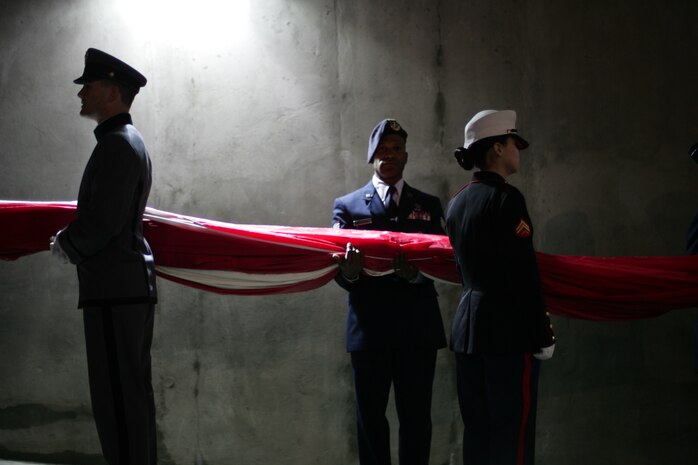 Marines, sailors, airmen, soldiers and West Point cadets wait with an outfield-sized American Flag before the first game of the World Series at Yankee Stadium, N.Y., Oct. 28. Service members unfurled a flag across the outfield and wounded warriors joined a United States Military Academy at West Point color guard as part of a ceremony honoring military veterans. (Official Marine Corps photo by Sgt. Randall A. Clinton)