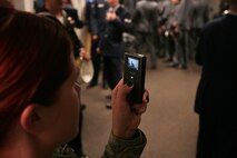 A soldier records video as Marines, sailors, soldiers, airmen and West Point cadets prepare their uniforms in the locker room at Yankee Stadium before the pregame ceremony honoring military veterans, Oct. 28. She received a Purple Heart Medal after being wounded in combat and joined wounded service members for a special recognition during the event. (Official Marine Corps photo by Sgt. Randall A. Clinton)
