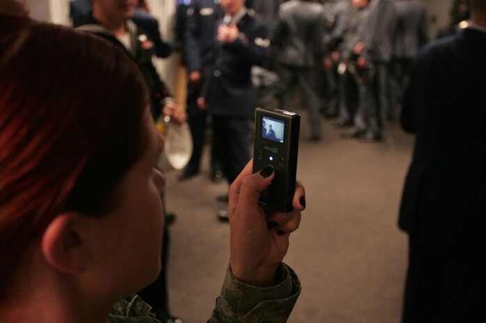 A soldier records video as Marines, sailors, soldiers, airmen and West Point cadets prepare their uniforms in the locker room at Yankee Stadium before the pregame ceremony honoring military veterans, Oct. 28. She received a Purple Heart Medal after being wounded in combat and joined wounded service members for a special recognition during the event. (Official Marine Corps photo by Sgt. Randall A. Clinton)