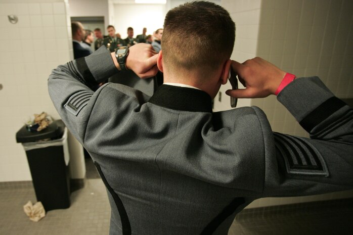 A West Point cadet tries to make a cell phone call while Marines, sailors, soldiers, airmen and West Point cadets prepare their uniforms in the locker room at Yankee Stadium before the pregame ceremony honoring military veterans, Oct. 28. Service members unfurled an outfield-sized flag and the United States Military Academy at West Point provided a color guard for the night. (Official Marine Corps photo by Sgt. Randall A. Clinton)