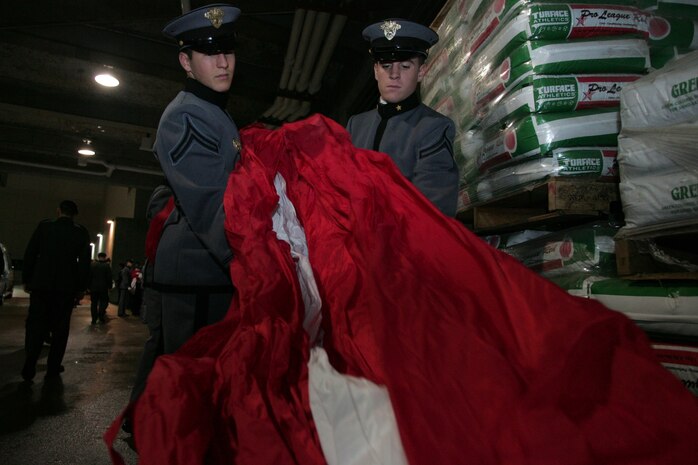 Marines, sailors, airmen, soldiers and West Point cadets wait with an outfield-sized American Flag before the first game of the World Series at Yankee Stadium, N.Y., Oct. 28. Service members unfurled a flag across the outfield and wounded warriors joined a United States Military Academy at West Point color guard as part of a ceremony honoring military veterans. (Official Marine Corps photo by Sgt. Randall A. Clinton)