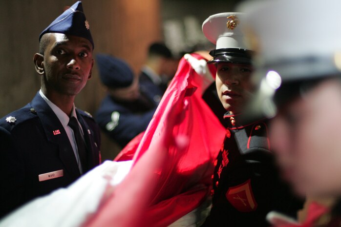 Marines, sailors, airmen, soldiers and West Point cadets wait with an outfield-sized American Flag before the first game of the World Series at Yankee Stadium, N.Y., Oct. 28. Service members unfurled a flag across the outfield and wounded warriors joined a United States Military Academy at West Point color guard as part of a ceremony honoring military veterans. (Official Marine Corps photo by Sgt. Randall A. Clinton)