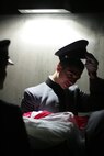 Nadi Kassim, a cadet at the United States Military Academy at West Point, waits with the American Flag inside Yankee Stadium. He was part of the Marine, soldier, sailor, airmen and West Point cadet detail that unfurled an American Flag before the first game of the World Series, Oct. 28. West Point also provided a color guard for the night's event honoring military veterans. (Official Marine Corps photo by Sgt. Randall A. Clinton)