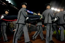Marines, sailors, airmen, soldiers and West Point cadets bring an outfield-sized American Flag onto Yankee Stadium before the first game of the 2009 World Series, Oct. 28, New York. (Official Marine Corps photo by Sgt. Randall A. Clinton)