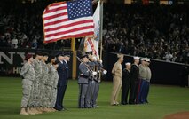 Wounded service members from each branch of the military flank the United States Military Academy at West Point color guard during a pregame event, Oct. 28, at Yankee Stadium, N.Y. The ceremony honored military veterans from all service branches.(Official Marine Corps photo by Sgt. Randall A. Clinton)