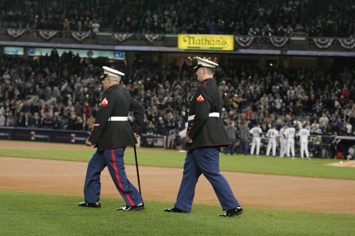 Cpl. Jeremy Stengel, a Waterford, Wi., native and Lance Cpl. Michael S. Stilson, from Clarkston, Wa., walk on field to join wounded service members from all branches of the military as part of a ceremony before the first game of the World Series at Yankee Stadium, N.Y., Oct. 28. Both Marines were wounded in action in 2007. The ceremony honored military veterans. Official Marine Corps photo by Sgt. Randall A. Clinton)