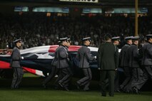Marines, sailors, airmen, soldiers and West Point cadets unfurl an outfield-sized American Flag across Yankee Stadium prior to the first game of the World Series, Oct 28, New York. The ceremony honored military veterans.(Official Marine Corps photo by Sgt. Randall A. Clinton)