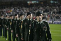 Marines, sailors, airmen, soldiers and West Point cadets march off the field after a pregame ceremony at Yankee Stadium, N.Y., Oct. 28. Service members unfurled a flag across the outfield, and wounded warriors joined a United States Military Academy at West Point color guard prior to the first game of the World Series. The ceremony honored military veterans.(Official Marine Corps photo by Sgt. Randall A. Clinton)