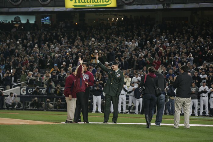 Army Capt. Anthony Odierno, joined by Michelle Obama, Jill Biden and Lawerence "Yogi" Berra, threw out the ceremonial first pitch before the first game of the World Series at Yankee Stadium, N.Y., Oct. 28. Odierno, son of the commanding general of Multi-National Force-Iraq, lost his arm when attacked on a patrol outside Bagdad in 2004. The ceremony honored military veterans. Berra served in the Navy during World War II. (Official Marine Corps photo by Sgt. Randall A. Clinton)