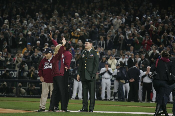 Army Capt. Anthony Odierno, joined by Michelle Obama, Jill Biden and Lawerence "Yogi" Berra, threw out the ceremonial first pitch before the first game of the World Series at Yankee Stadium, N.Y., Oct. 28. Odierno, son of the commanding general of Multi-National Force-Iraq, lost his arm when attacked on a patrol outside Bagdad in 2004. The ceremony honored military veterans. Berra served in the Navy during World War II. (Official Marine Corps photo by Sgt. Randall A. Clinton)