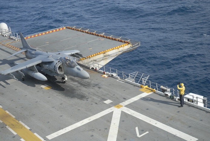 AV-8B Harriers attached to Marine Medium Tilt Rotor Squadron-162, (Reinforced), 24th Marine Expeditionary Unit, lands on the flight deck of USS Nassau.  Marines and sailors coordinate aircraft landings as part of the 24th MEU's Composite Training Unit Exercise, the Nassau Amphibious Ready Group’s deployment certification exercise.  (U.S. Marine Corps photo by Lance Cpl. Sean Ross)