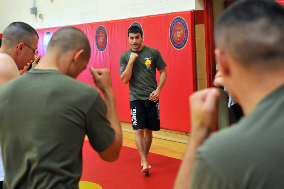 Matt Phinney, a boxing coach with Train the Troops, teaches Marines striking techniques during a half-day seminar at the Marine Corps Air Station in Yuma, Ariz., Oct. 28, 2009. Train the Troops, sponsored and organized by Ranger Up a mixed martial arts clothing company visited the station to teach Marines mixed martial arts.