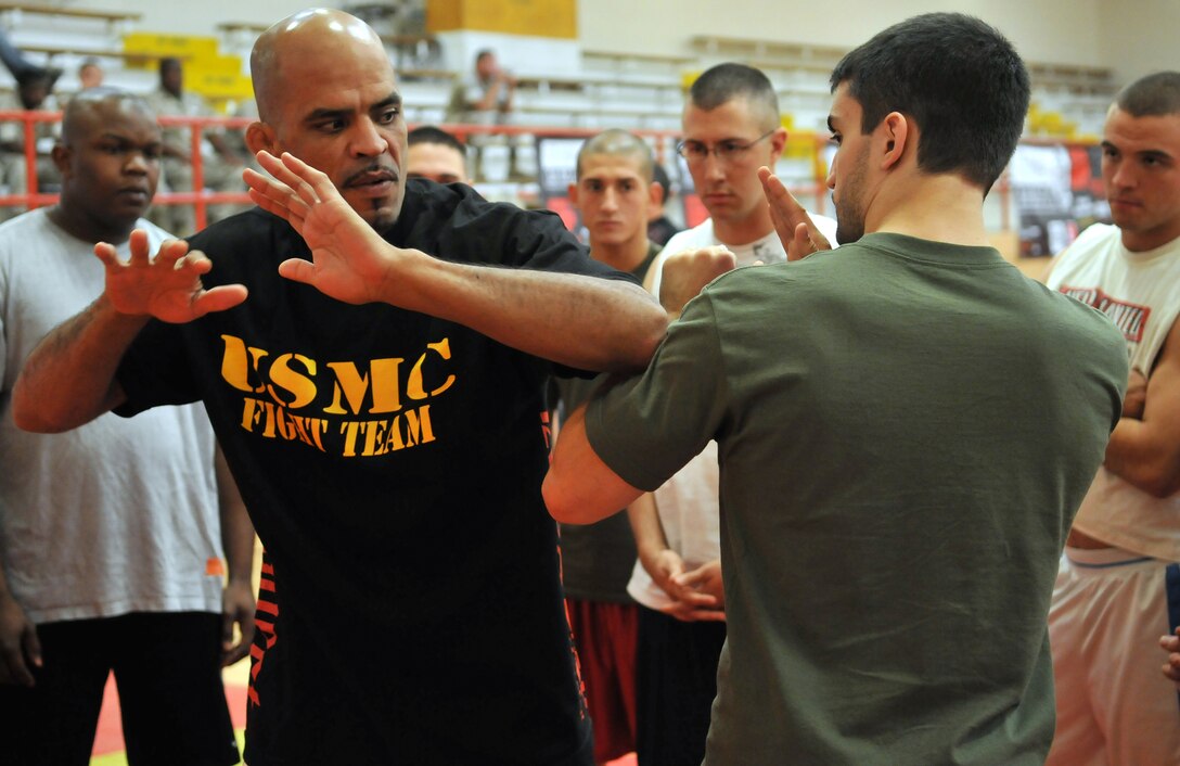 Jorge “El Conquistador” Rivera, mixed martial arts fighter, and Matt Phinney, boxing instructor, demonstrate striking techniques for Marines in the gym at the Marine Corps Air Station in Yuma, Ariz., Oct. 28, 2009. Train the Troops, sponsored and organized by Ranger Up, an MMA clothing company, visited the station to teach Marines mixed martial arts.