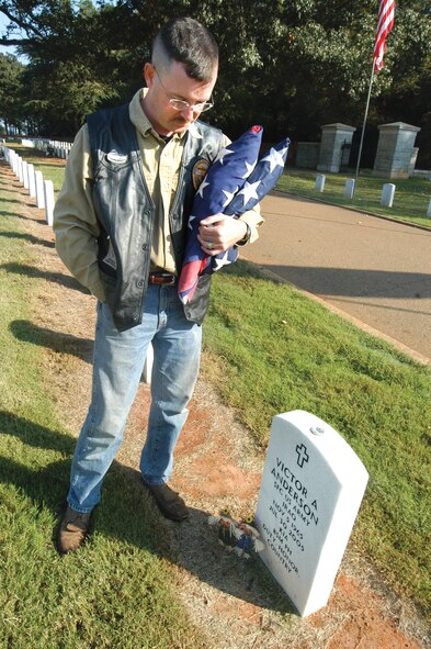 Army Sgt. 1st Class Jim Strickland visited the grave of a fallen comrade while at Andersonville. U. S. Air Force photo by Sue Sapp   