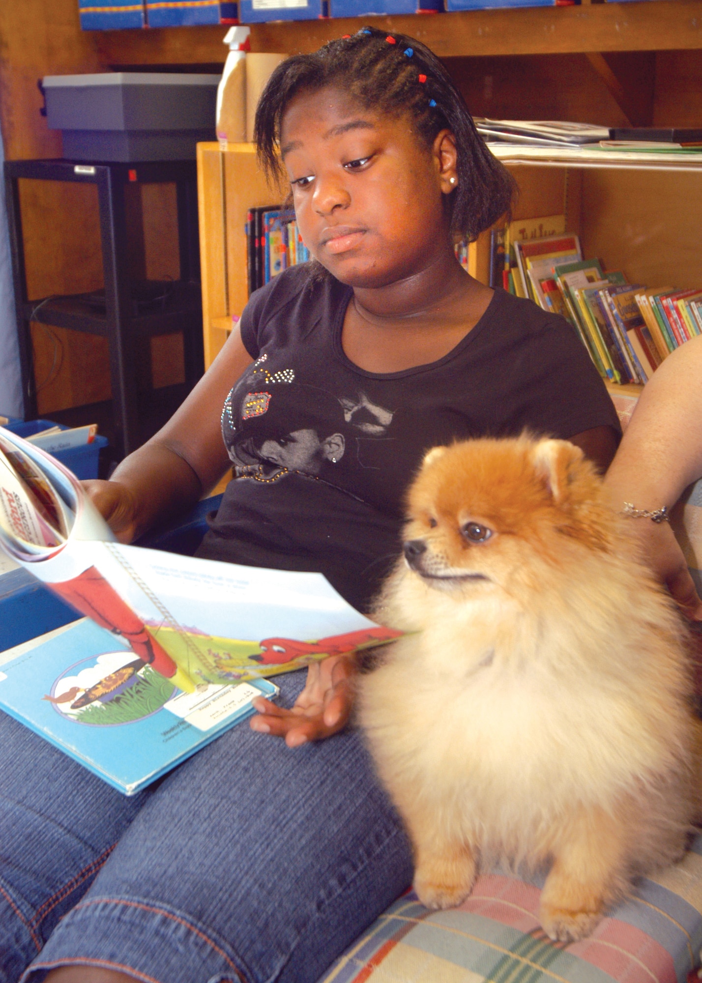 Peyton Baskerville, 6th grade, reads to Flynn. U. S. Air Force photo by Sue Sapp    