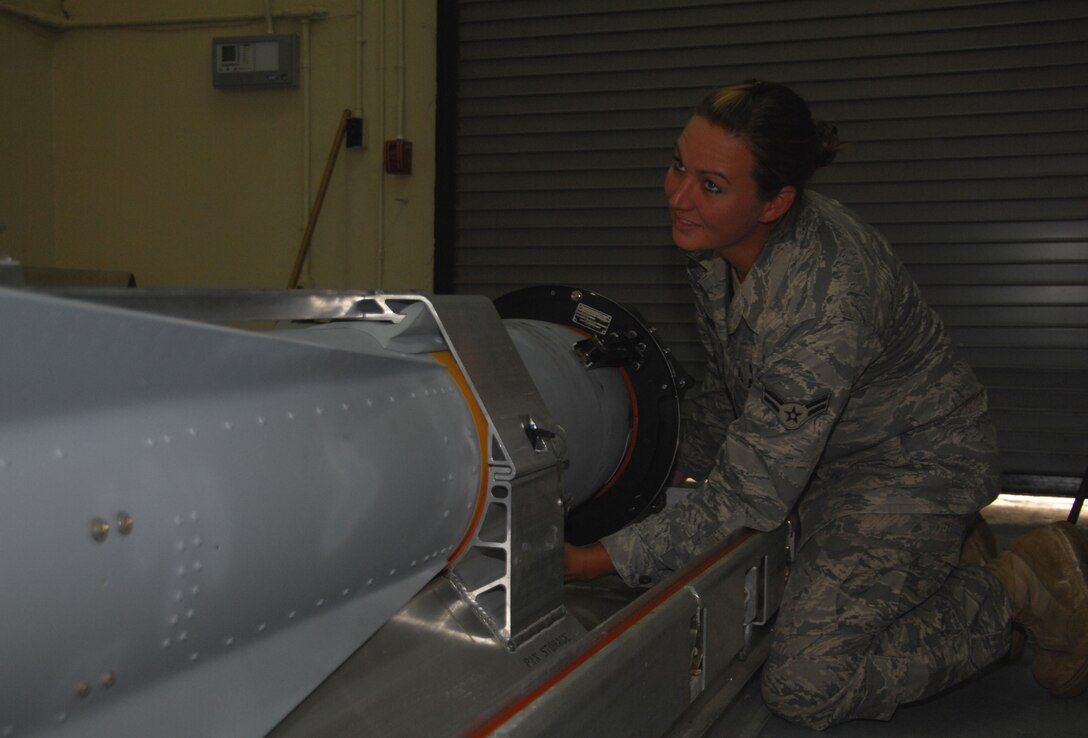ANDERSEN AIR FORCE BASE, Guam - Airman 1st Class Megan Minturn, 36th Munitions Squadron conventional maintenance and precision guidance missile crew member, connects an SM-787 infrared target simulator to an AGM-65 missile in order to test the missile's infrared sensor here Oct. 27. Airman Minturn was recognized by her leadership as 'Top Performer' for her steadfast dedication on and off duty. (U.S. Air Force photo by Senior Airman Shane Dunaway)