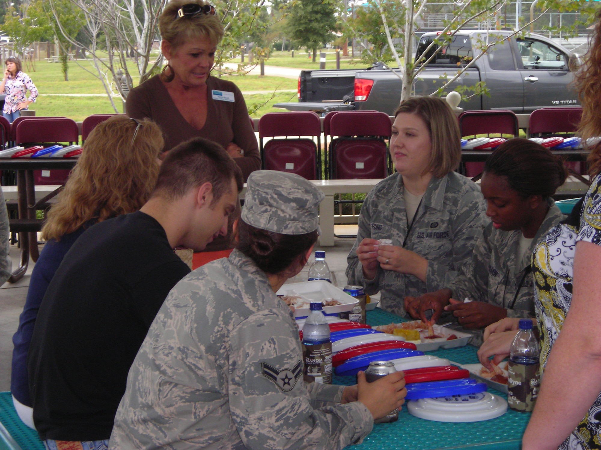 Patsy Bland of the Niceville-Valparaiso Chamber of Commerce visits with Airmen at a Dorm Residents Appreciation Picnic at the Community Park Oct. 28. The sponsors also provided Frisbees and koozies to Airmen. (Air Force photo by Airman 1st Class Joe McFadden.)