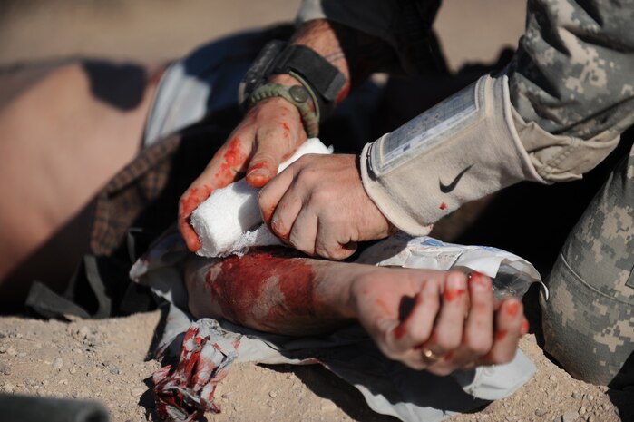 NEVADA TEST and TRAINING RANGE, Nev. -- A U.S. Army Special Forces Soldier treats a simulated Afghan civilian victim from a simulated roadside bomb during a training at the Urban Operations Center on the Nevada Test and Training Range, Oct. 21, 2009. Special Forces Units from all branches of service and allied nations use the facilities on the NTTR for a multitude of different training. (U.S. Air Force photo by Airman 1st Class Brett Clashman/Released)