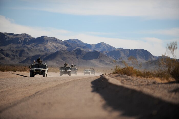 NEVADA TEST and TRAINING RANGE, Nev. -- U.S. Special Forces in  HUMVEES proceed on a training mission down the road at the Urban Operations Center on the Nevada Test and Training Range, Oct. 21, 2009. Special Forces Units from all branches of service and allied nations use the facilities on the NTTR for a multitude of different training. (U.S. Air Force photo by Airman 1st Class Brett Clashman/Released)