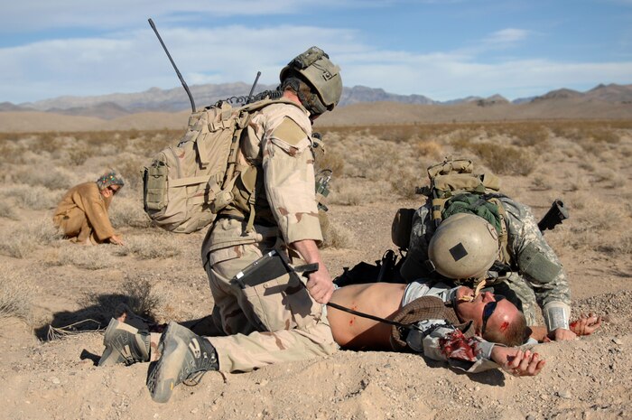 NEVADA TEST and TRAINING RANGE, Nev. -- U.S. Air Force Joint Terminal Attack Controller Airman assists a U.S. Army Special Forces Soldier with treating a simulated civilian victim from a simulated roadside bomb at the Urban Operations Center on the Nevada Test and Training Range, Oct. 21, 2009. Special Forces Units from all branches of service and allied nations use the facilities on the NTTR for a multitude of different training. (U.S. Air Force photo by Airman 1st Class Brett Clashman/Released)