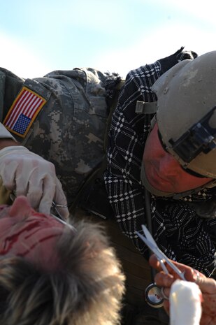 NEVADA TEST and TRAINING RANGE, Nev. -- U.S. Army Special Forces medic provides real world first aid to a man acting as an insurgent during a training exercise at the Urban Operations Center on the Nevada Test and Training Range, Oct. 21, 2009. Special Forces Units from all branches of service and allied nations use the facilities on the NTTR for a multitude of different training.  (U.S. Air Force photo by Tech. Sgt. Michael R. Holzworth)(released)