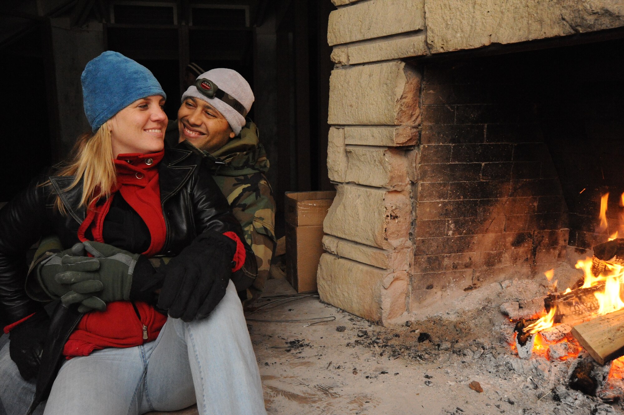 Capt. Adrian Spencer, 22nd Operations Group, and his wife Katherine, warm by a campfire Oct. 10, 2009, during a McConnell Chapel Weekend Retreat at Rock Springs 4-H Center in Junction City, Kan. Retreats are one of many family-oriented programs available to Team McConnell members. July 2009 to July 2010 is the Year of the Air Force Family. Throughout the year, bases across the globe will focus on improving programs geared toward Air Force families. (U.S. Air Force photo/Tech. Sgt. Chyrece Campbell) 