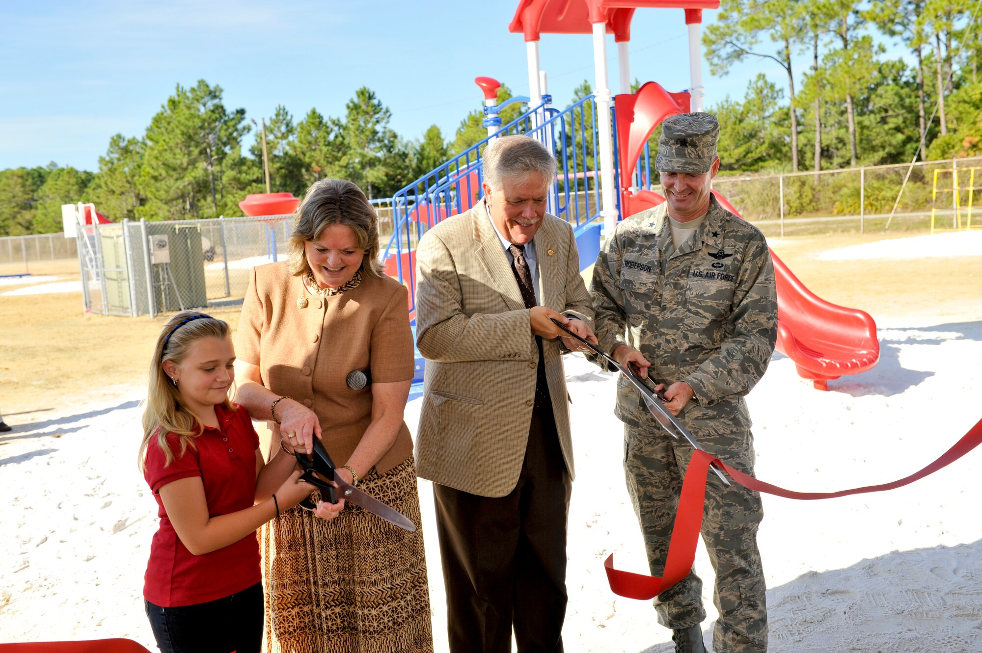 Brig. Gen. Darryl Roberson, 325th Fighter Wing Commander; William Husfelt, Bay District Schools Superintendant; Libbie Pippin, Tyndall Elementary Principal; and Danika Plotkin, Tyndall Elementary student, cut a ribbon marking the completion of the time critical response action phase of a soil clean-up effort at Tyndall Elementary Oct. 29. (U.S. Air Force photo by Jonathan Gibson)
