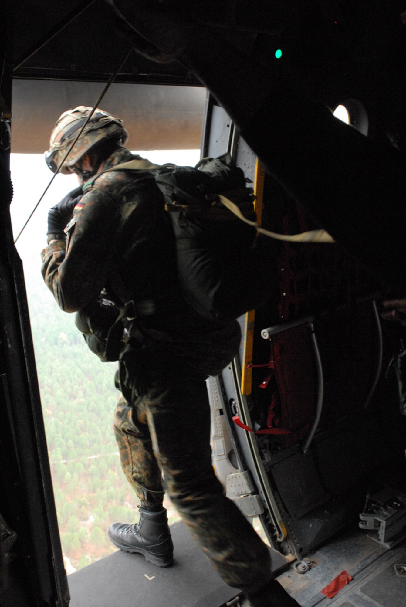 A German paratrooper training with the 82nd Airborne Division's Advanced Airborne school at Fort Bragg, N.C. jumps out of a C-130H3 Oct. 27 as part of a joint force exercise at Pope AFB, N.C. The JFEX focused on cohesive training between the Air Force and Army to reestablish forcible entry capability through air power. (U.S. Air Force photo by Senior Airman Nathan Allen) 