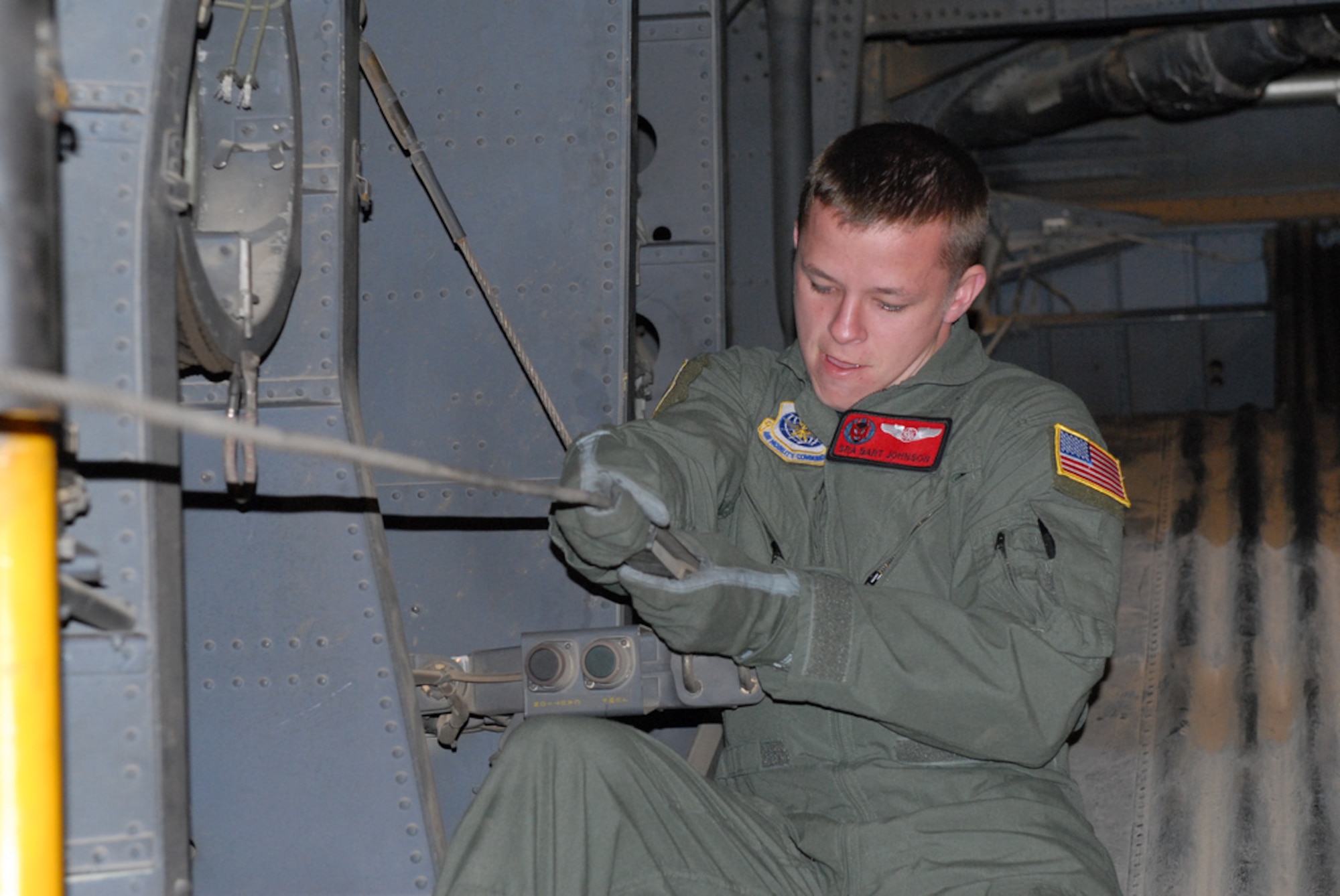 Senior Airman Bart Johnson, 50th Airlift Squadron C-130H3 loadmaster from Little Rock Air Force Base, Ark., secures a paratrooper jump cable Oct. 27 as part of a joint force exercise at Pope AFB, N.C. The JFEX focused on cohesive training between the Air Force and Army to reestablish forcible entry capability through air power. (U.S. Air Force photo by Senior Airman Nathan Allen)