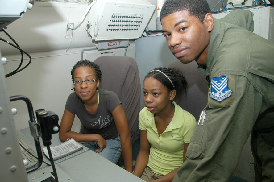 Alicia and Kierra powell the daughter's of MSgt Anthony Powell of 12 ACCS / FE ; learn about the JSTARS Aircraft from A1C Rickey Harris.  (USAF Photo by TSgt Tim Neville).