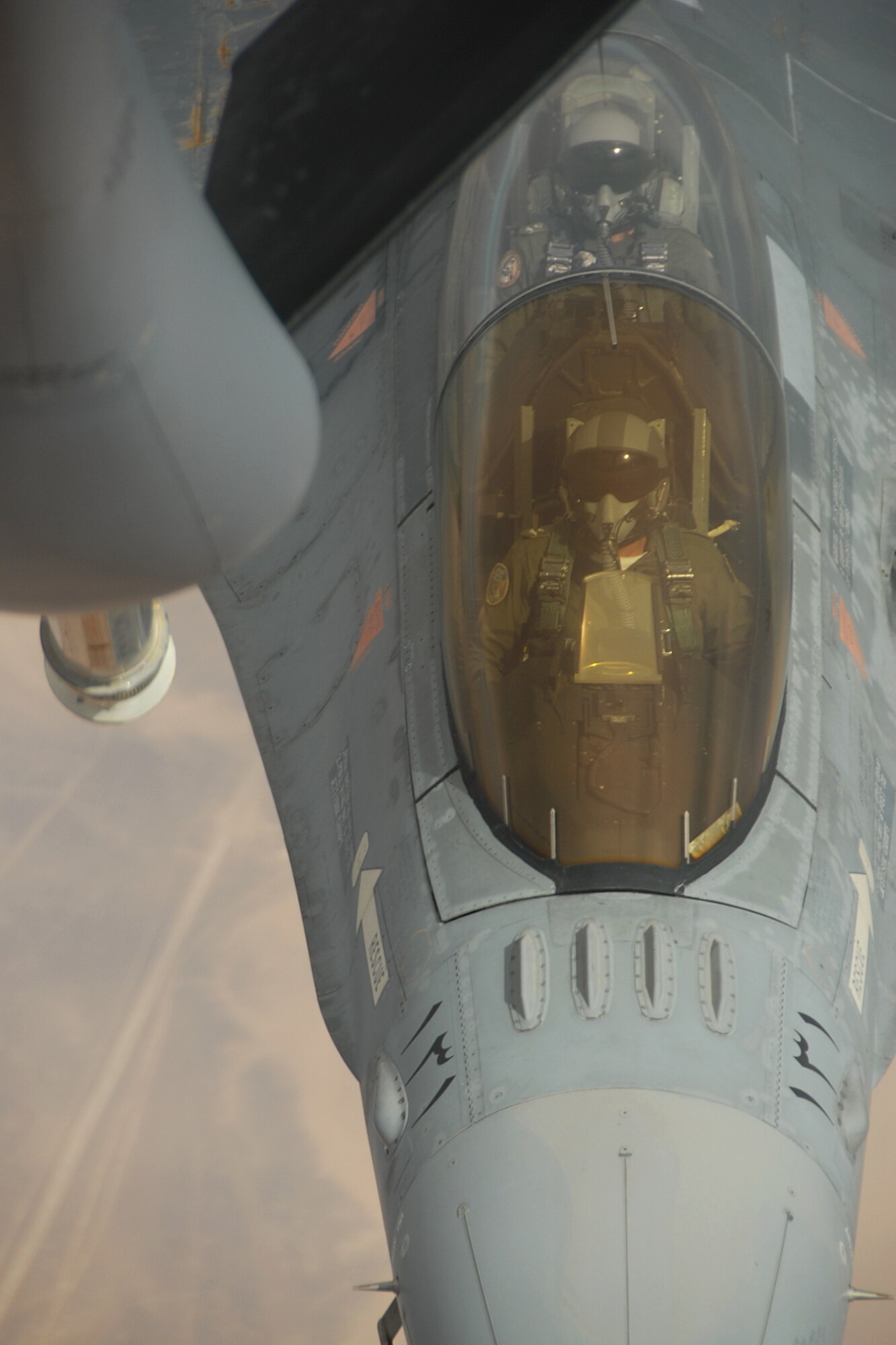 A Royal Jordanian Air Force F-16 Fighting Falcon aircraft fighter pilot flies in to connect to a U.S. Air Force KC-135 Stratotanker on Oct. 19, 2009, over Jordan, along with other F-16 pilots from the 169th Fighter Wing at McEntire Joint National Guard Base, S.C., and Mwaffaq Salti Air Base in Azraq, Jordan. The air refueling was also being used as a training exercise on the safety and proper procedures for refueling while in flight. U.S. Airmen were in Jordan for the 2009 Eager Tiger 10, Falcon Air Meet, a friendly competition between the air forces of the U.S. and the Middle East, as well as other F-16 aircraft users from around the world. (U.S. Air Force Photo/Tech. Sgt. Caycee Cook)