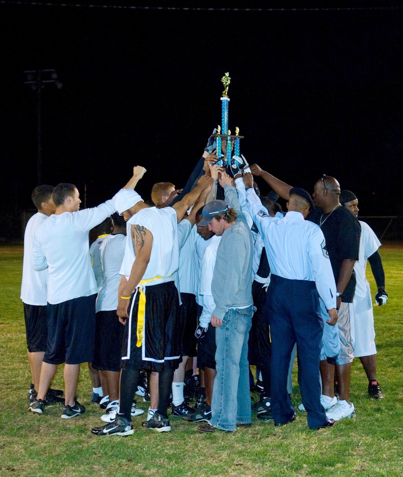 The 95th Security Forces Squadron celebrates after winning the Intramural Football Championship Game Oct. 26. The 95th SFS won 25-21 and 12-7. (Air Force photo/Mike Cassidy)