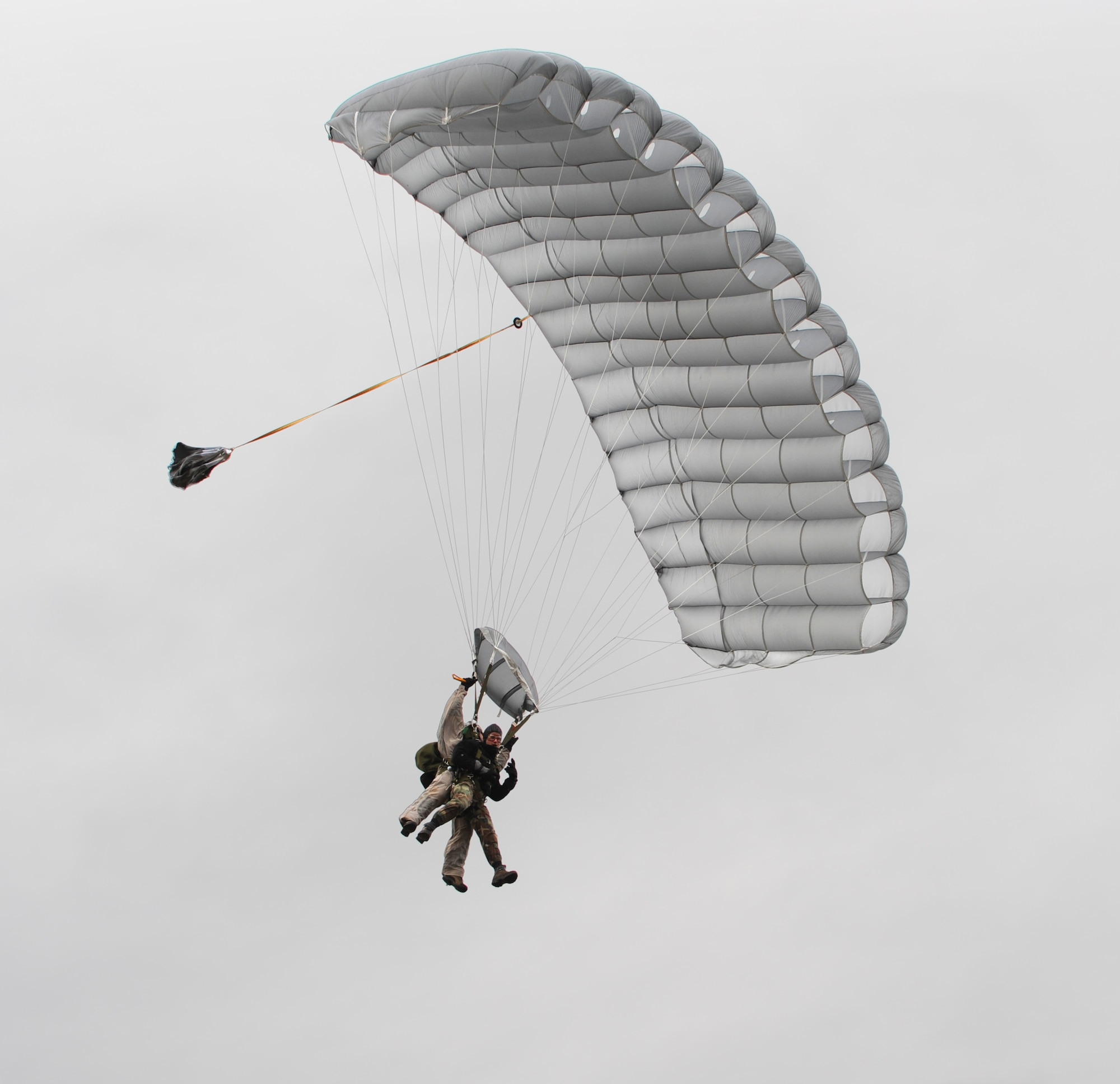 FORT RICHARDSON, Alaska -- 1st Lt. John Romspert pilots a tandem jump with passenger Senior Airman Don Lacy during a pararescuemen training jump at the Malamute drop zone Oct. 21. With few people qualified to do tandem jumps, only five-to-10 tandem training jumps occur each year. Romspert is a combat rescue pilot with the 212th Rescue Squadron and Lacy is an aircrew flight equipment specialist with the 176 Operational Support Flight both at Kulis Air National Guard Base, Alaska. (U.S. Air Force photo/Senior Airman Cynthia Spalding)