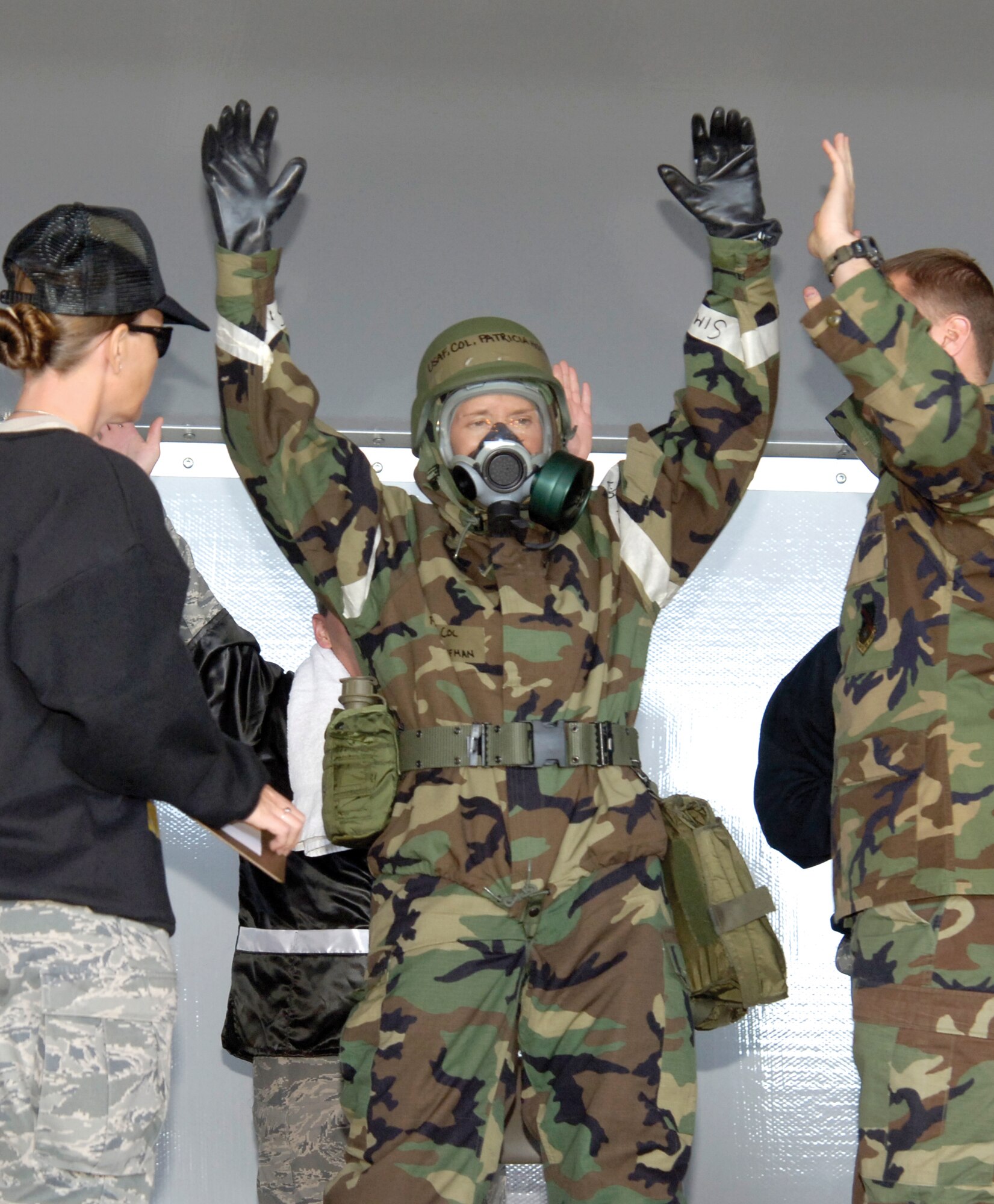 Col. Patricia Hoffman, 552nd Air Control Wing commander, was the fastest in pulling her chemical gear on, winning a competition during the Pre-ORI rally Oct 27.  She earned an “Outstanding” from Airmen, role-playing inspectors, and cheers from the audience after her bout with Col. Evan Miller, 76th Propulsion Maintenance Group director, and Col. Allen Jamerson, 72nd Air Base Wing and Tinker installation commander. (Air Force photo by Margo Wright)