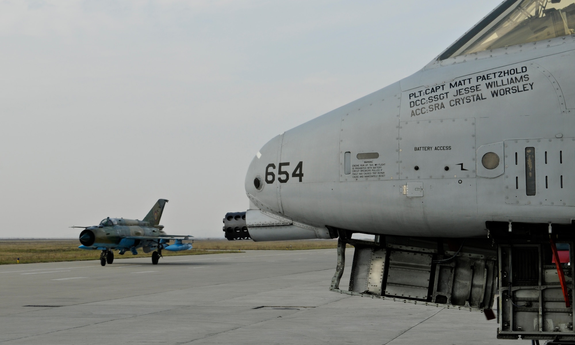 CAMPIA TURZII, Romania – A MIG 21 taxis past a U.S. Air Force A-10 Thunderbolt II on the flight line of the 71st Air Base Wing Oct. 26. Members of Spangdahlem Air Base are deployed to Romania in support of Operation Dacian Thunder 2009 and flew about 100 sorties; half of were be with the Romanian air force. (U.S. Air Force photo/Senior Airman Benjamin)