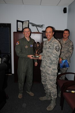 Master Sergeant Kevin French is presented a recruiting trophy by Colonel Lewis (U.S. Air Force Photo/Capt Shane Huff)